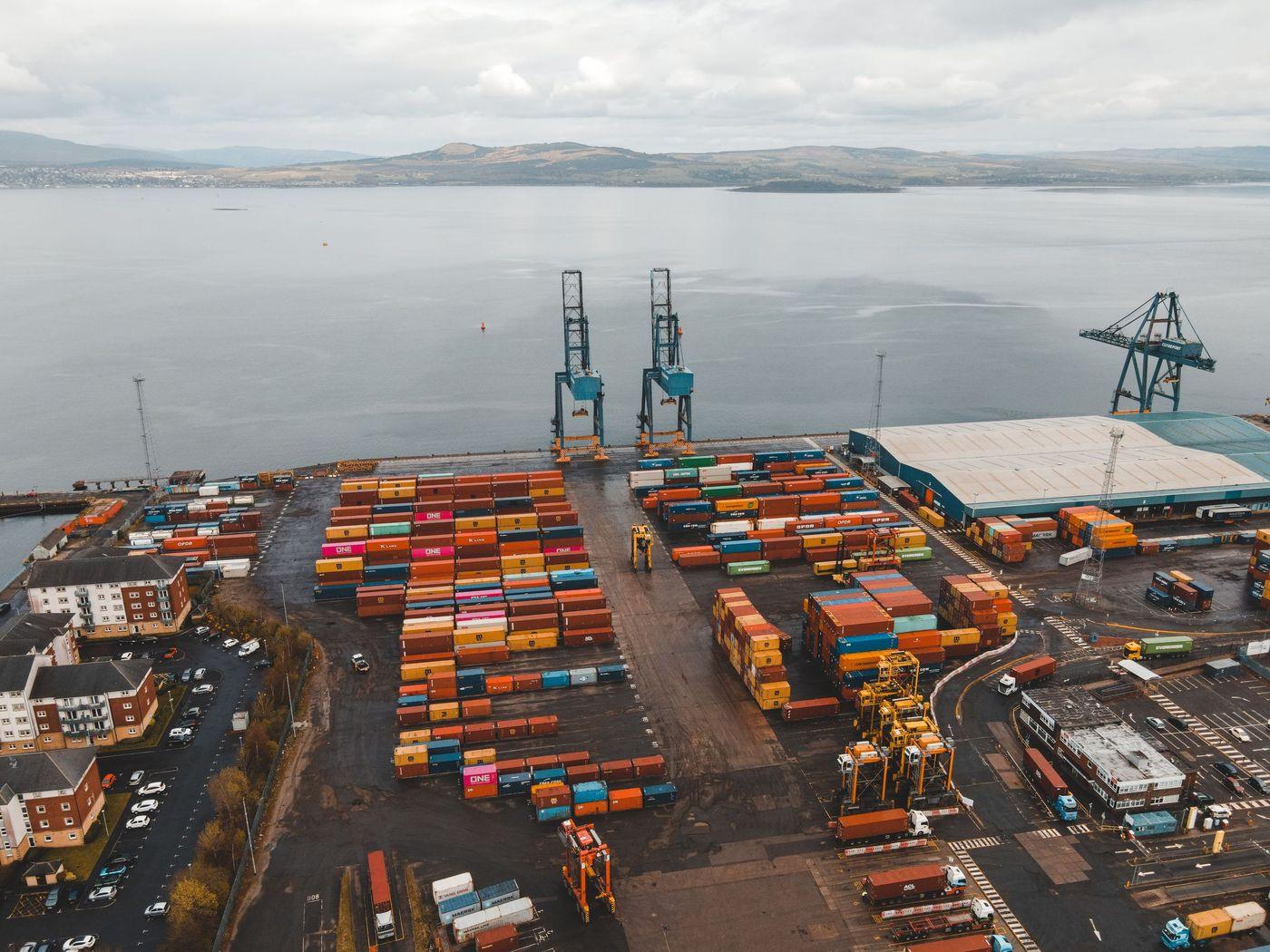 Gantry cranes and stacked containers at a working terminal